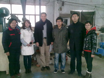 Customer-standing-alongside-flour-mill-grinder-technical-staff